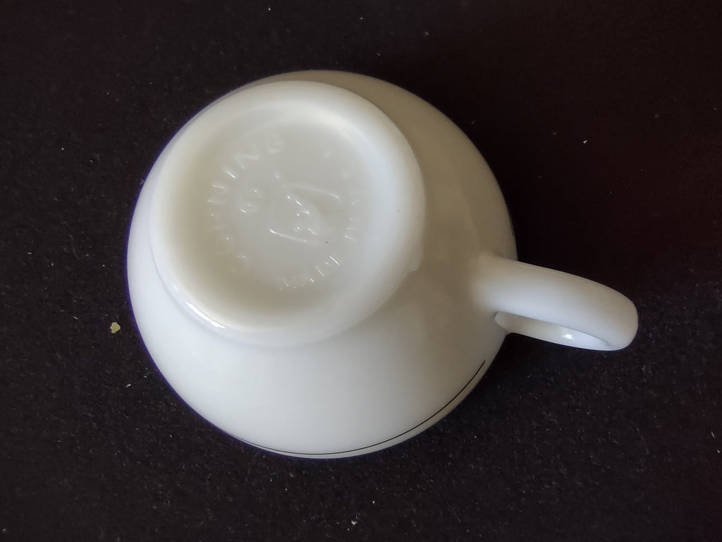 Close-up of green stripe banding and handle on vintage Buffalo China milk glass diner cup