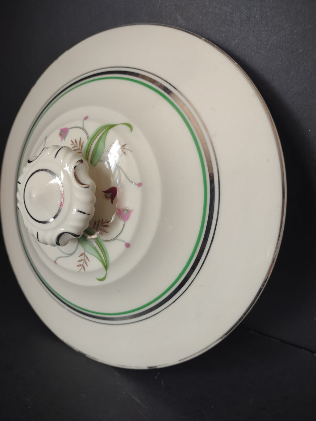 Vintage off-white banded plate back view with ruler showing approximately 10 inches diameter
