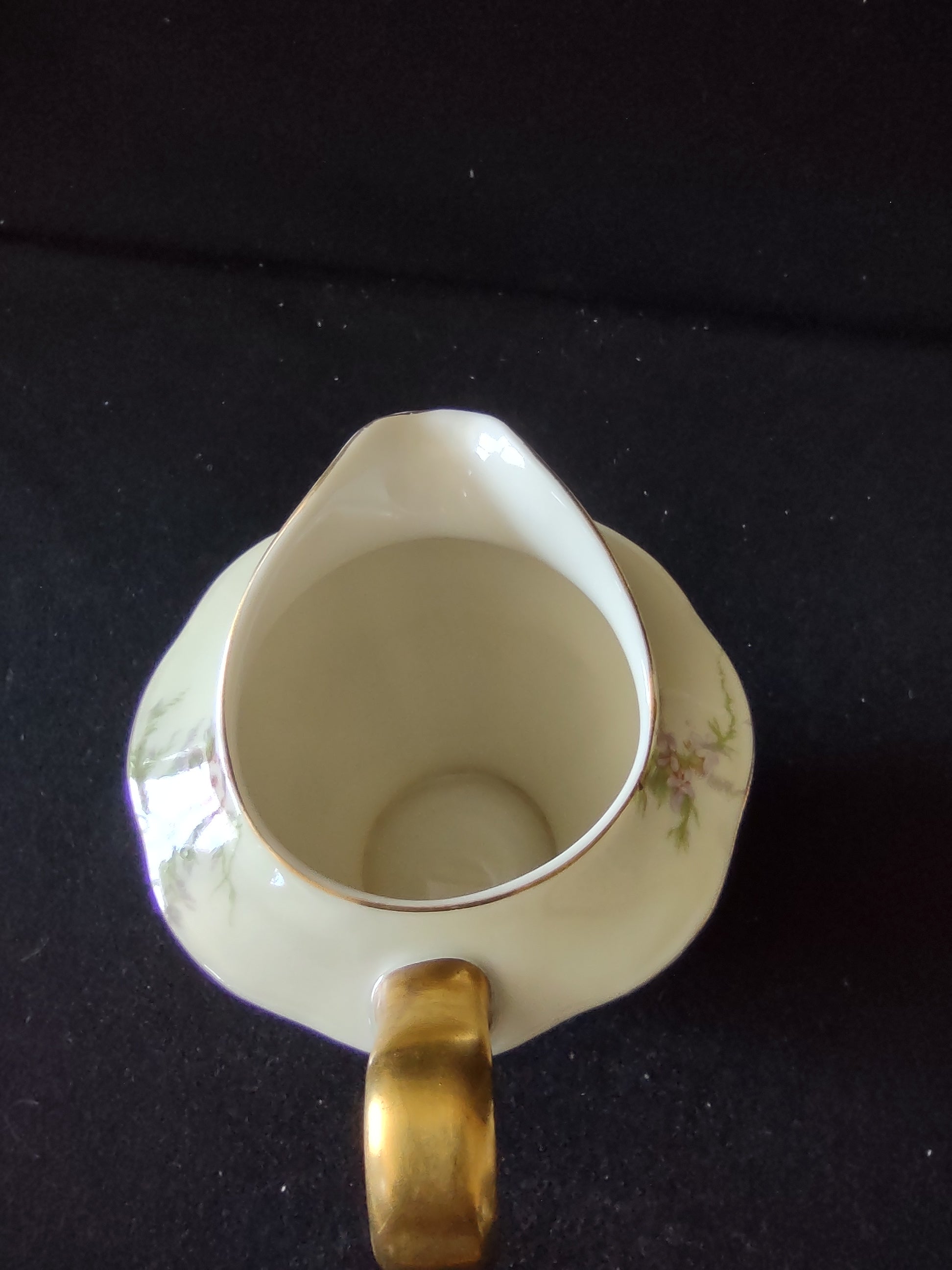 Close-up of Theodore Haviland Rosalinde creamer showing gold handle and pink floral spray detail