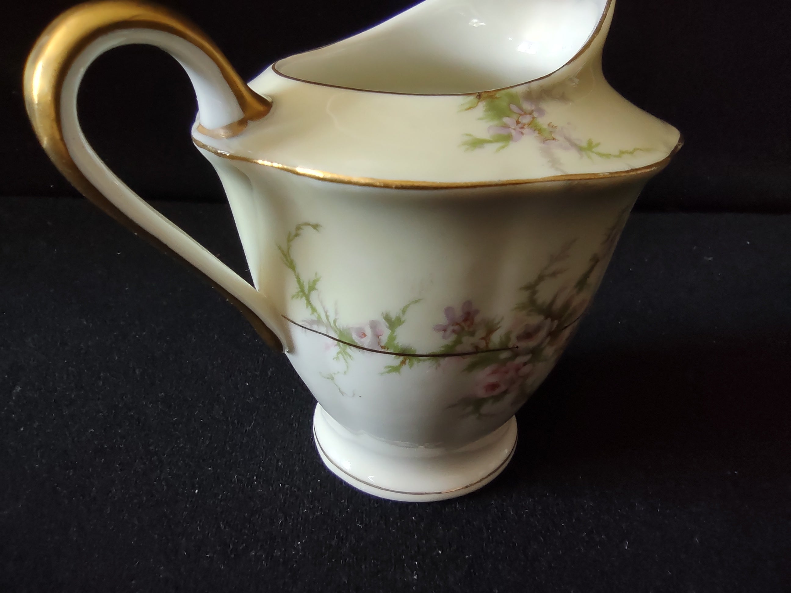 Theodore Haviland Rosalinde creamer front view showing ruffled rim and floral pattern