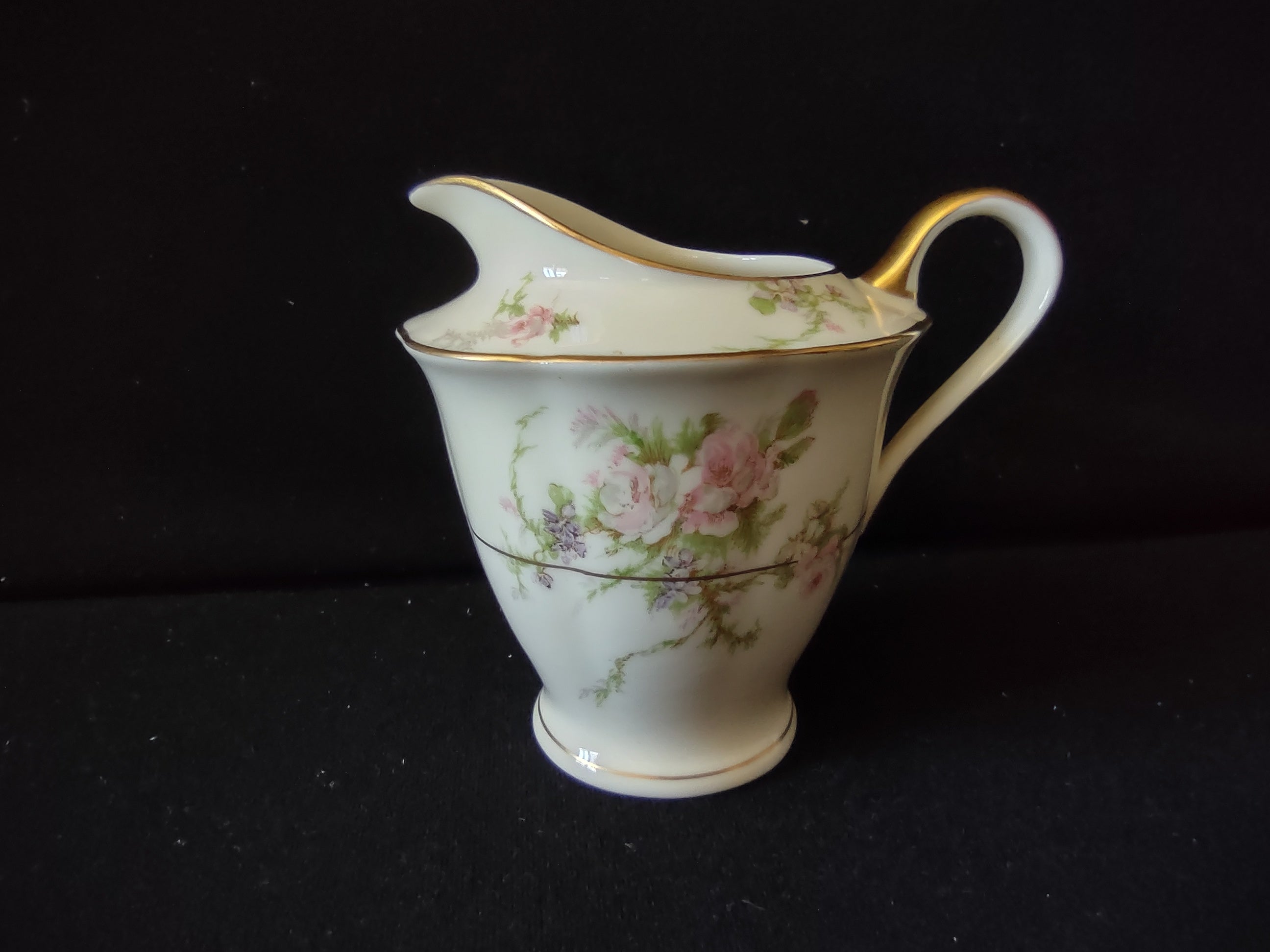 Theodore Haviland Rosalinde creamer top view showing scalloped rim and gold handle