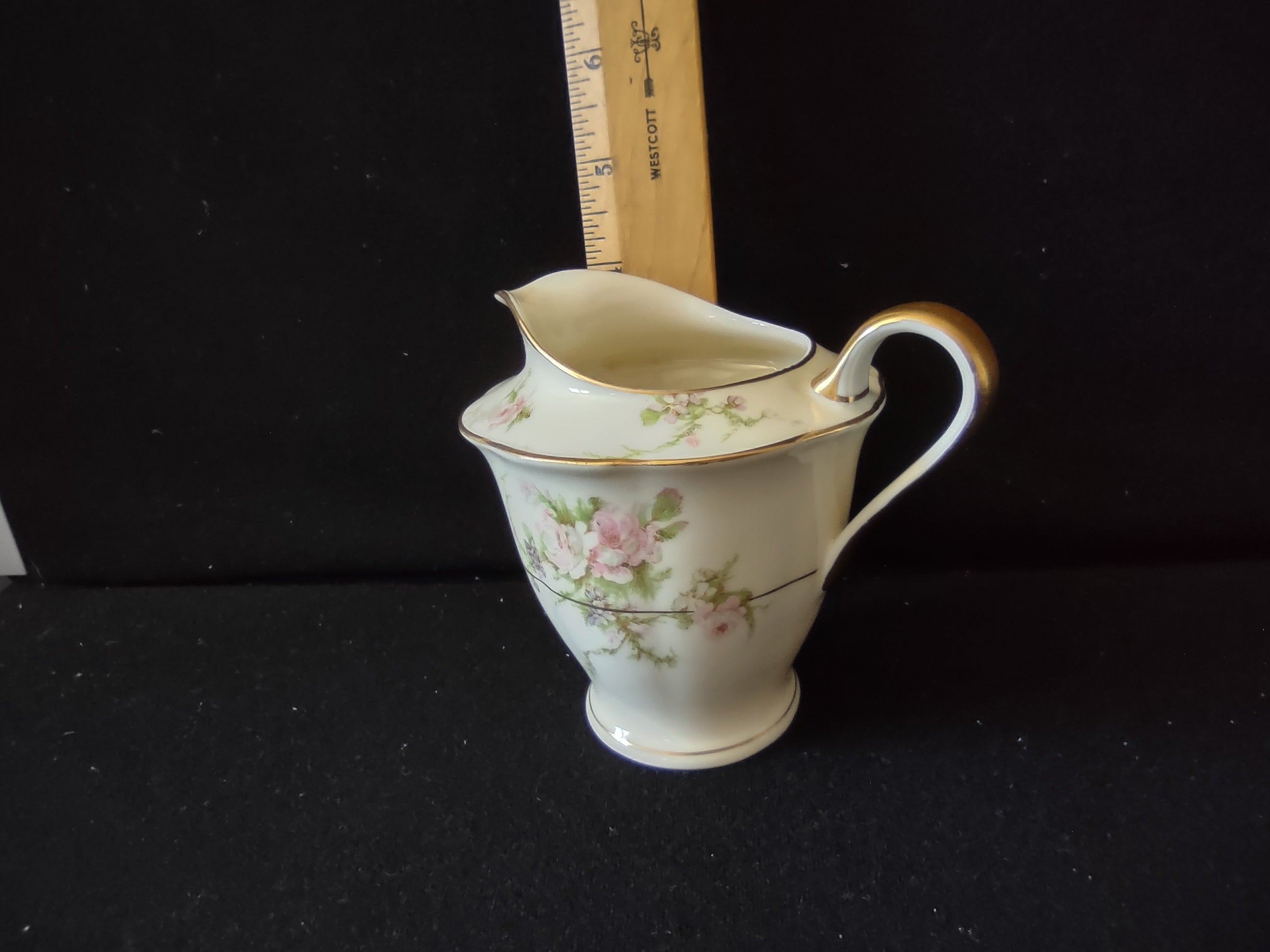 Theodore Haviland Rosalinde creamer angled view showing ruffled rim and floral decoration