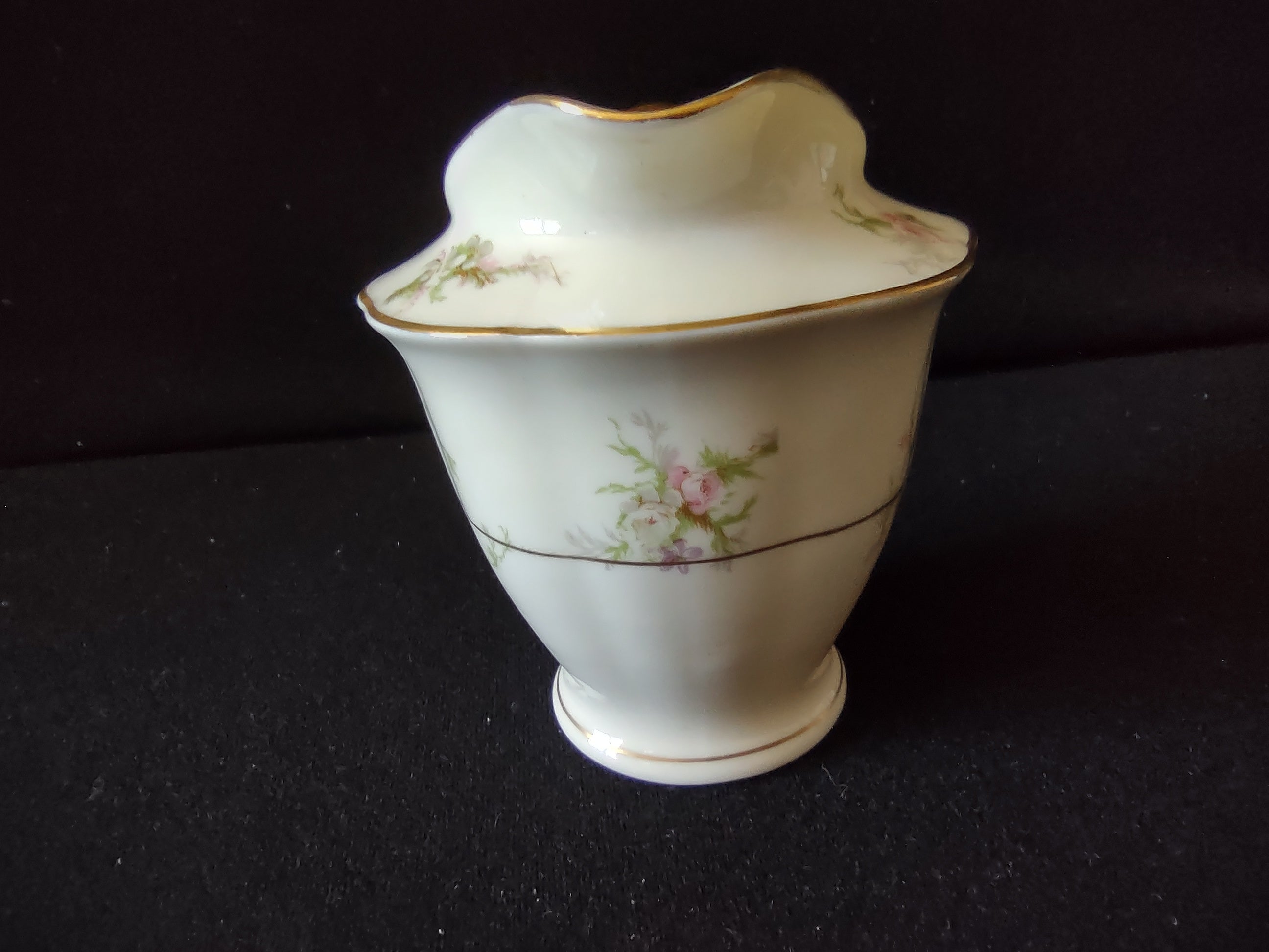 Theodore Haviland Rosalinde creamer side view showing crack line on exterior body
