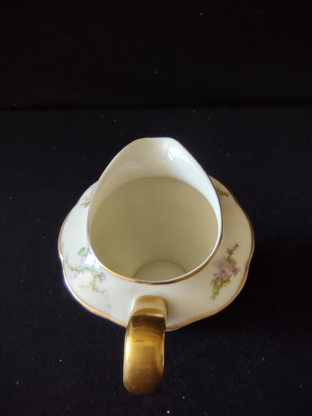 Theodore Haviland Rosalinde creamer opposite side view showing crack and floral spray