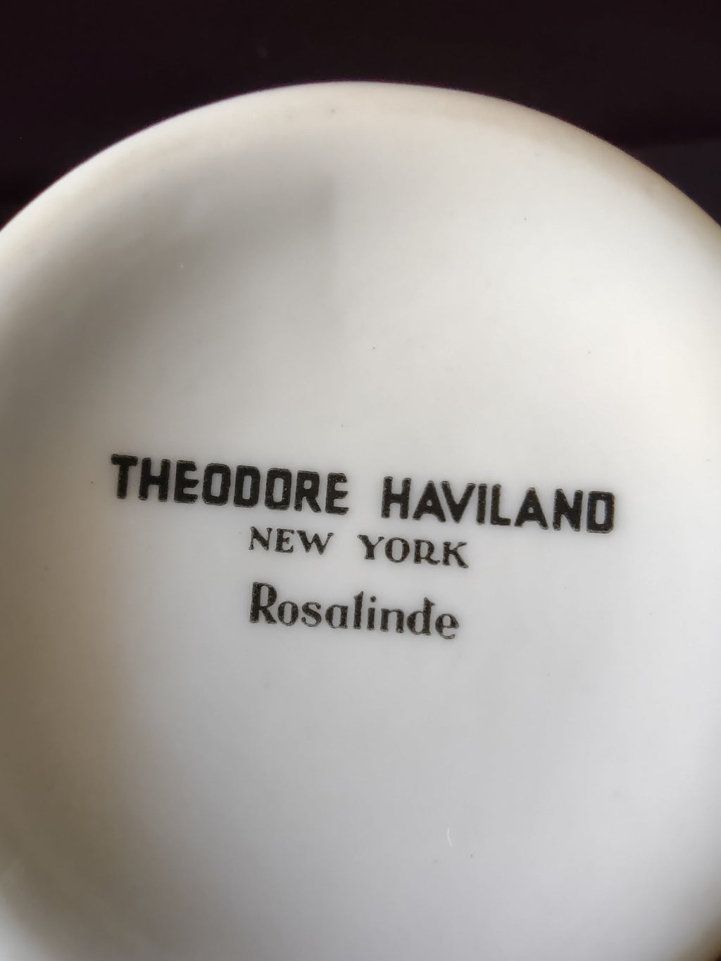 Theodore Haviland Rosalinde creamer front view showing pink floral pattern and gold handle