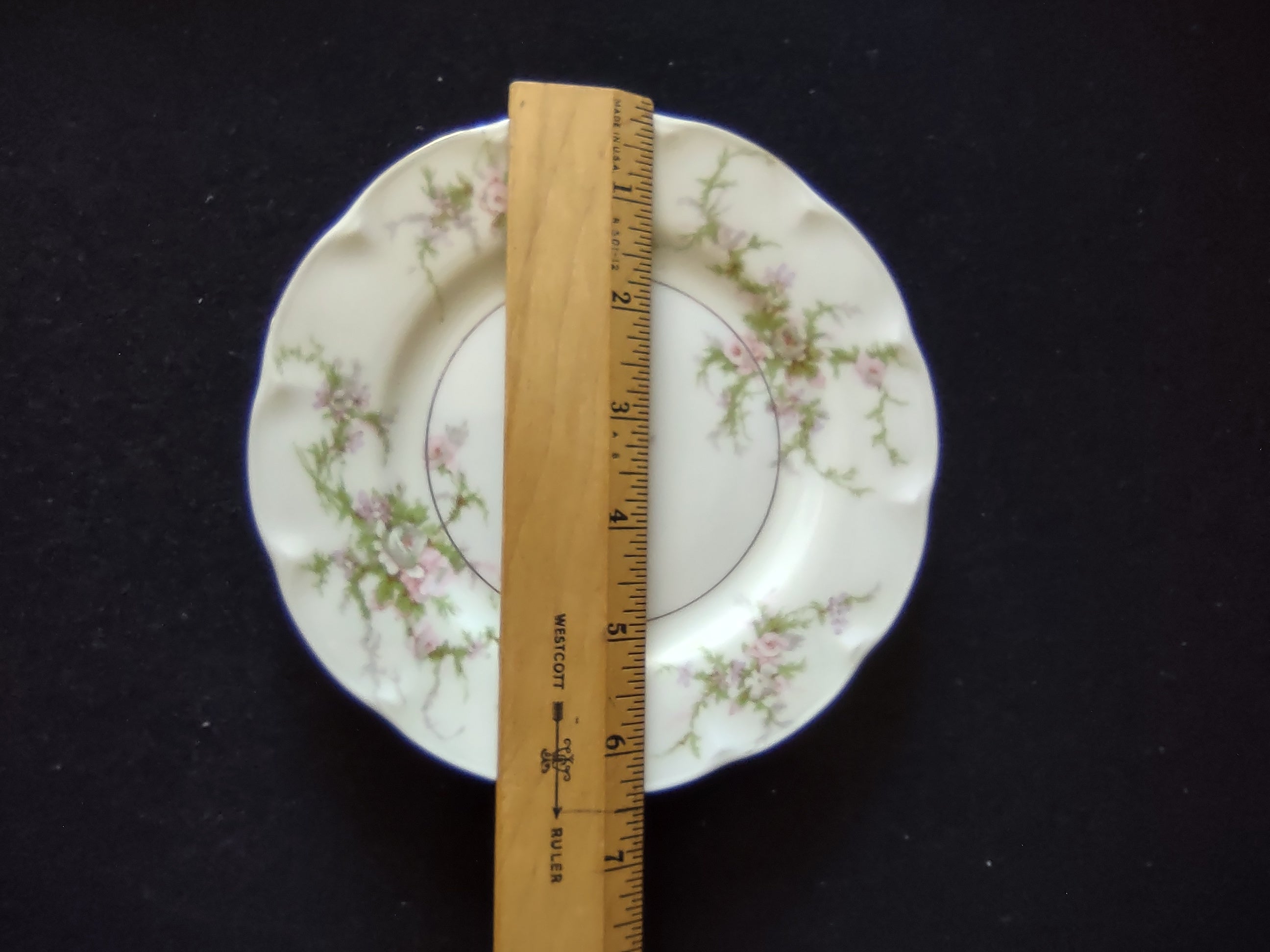 Theodore Haviland Rosalinde plate with ruler showing approximately 6 inch diameter