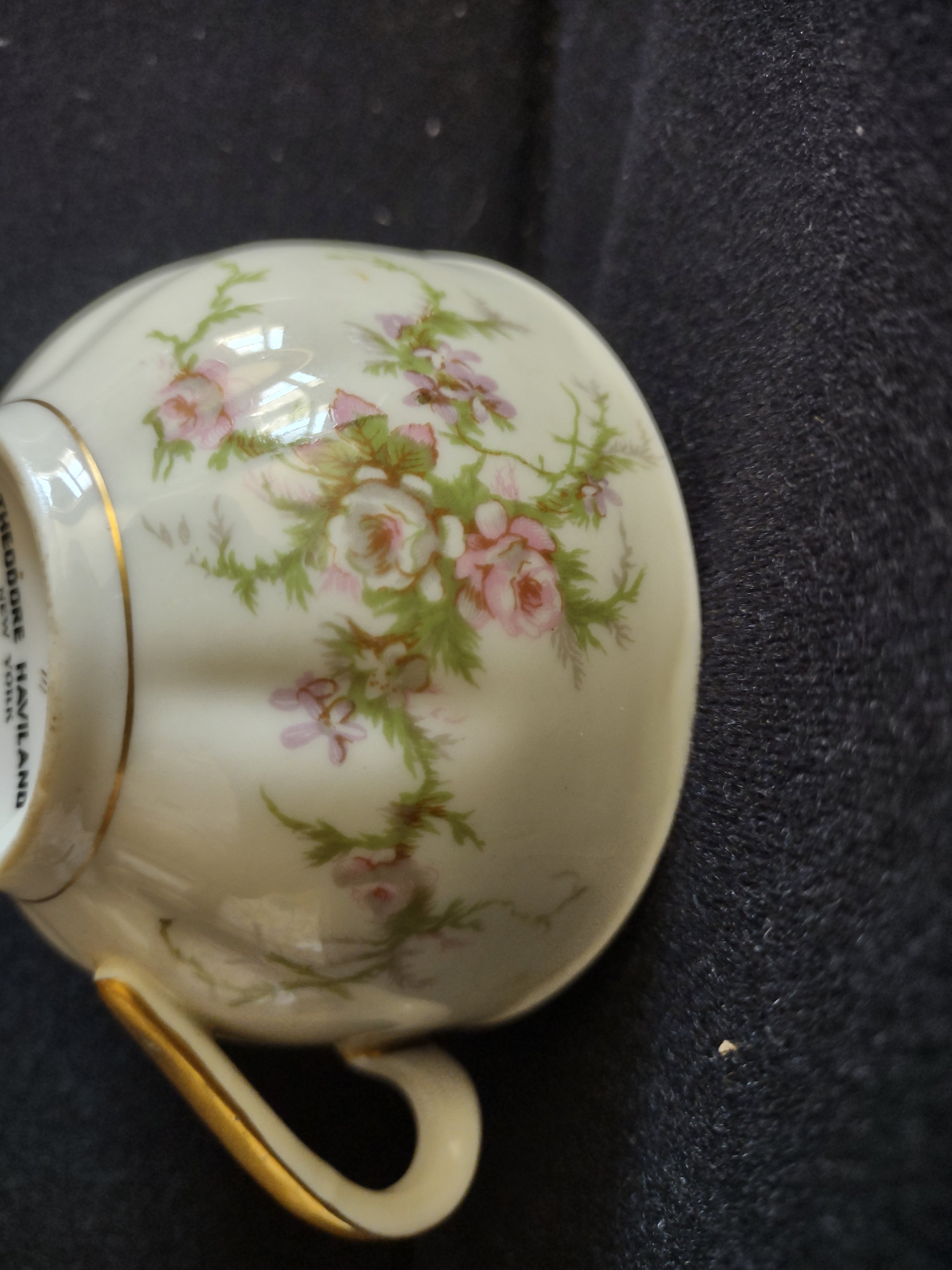 Theodore Haviland teacup angled view showing pink roses and gold trim