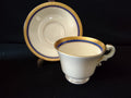 Syracuse China Old Ivory footed cup side view with scrolled handle and gold trim