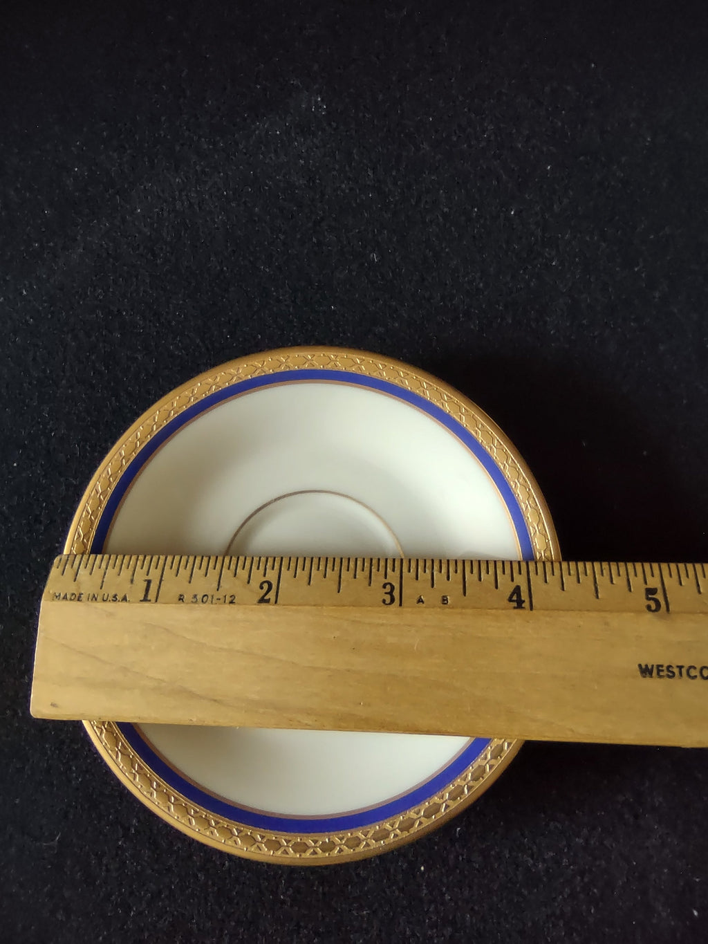 Syracuse China Old Ivory cup interior overhead view showing gold band and cobalt blue stripe