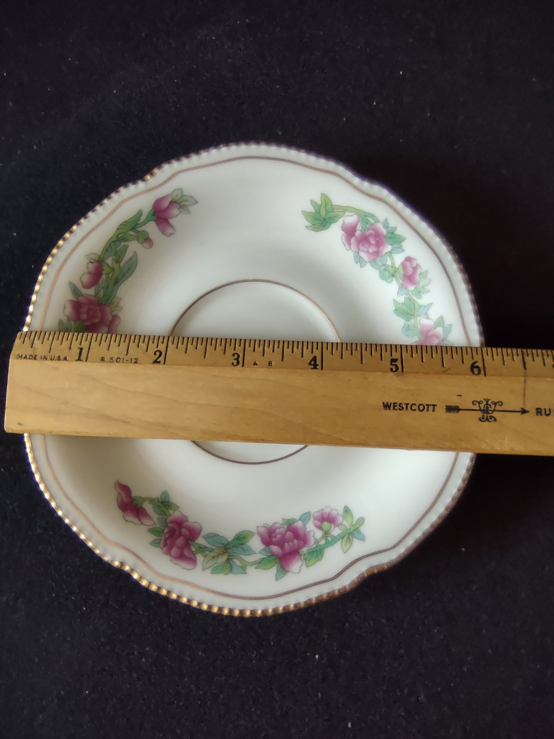 Single saucer with ruler showing approximately 6 inch diameter