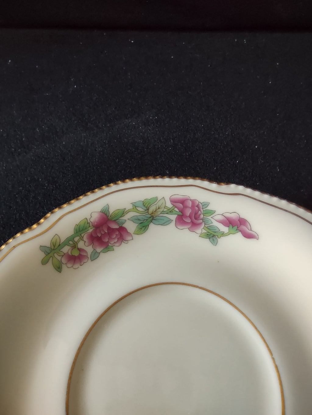 Pink rose garland pattern detail close-up on saucer rim