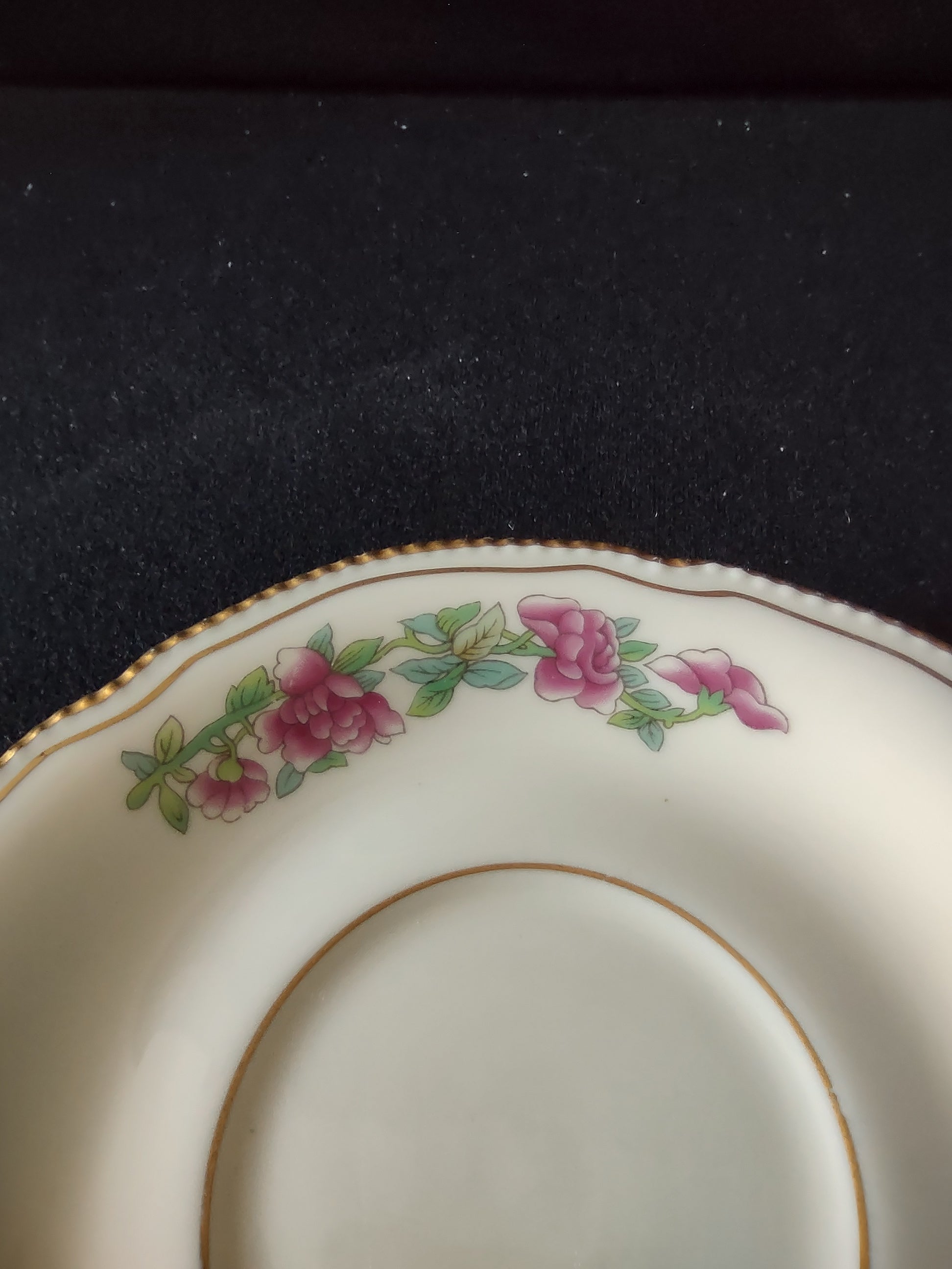 Pink rose garland pattern detail close-up on saucer rim