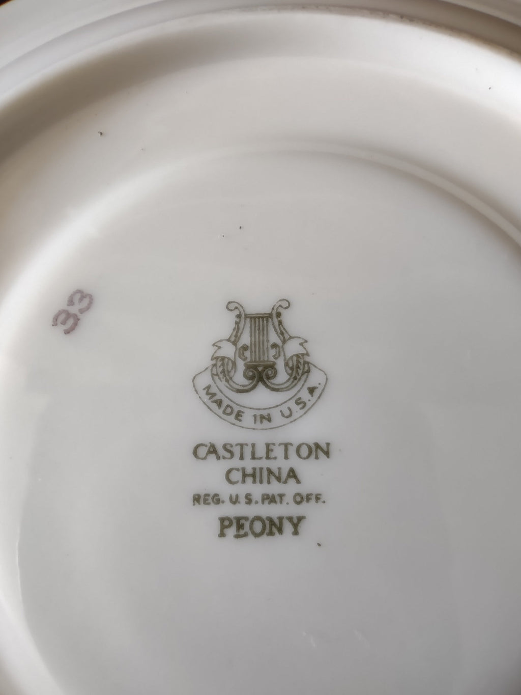 Castleton China Peony saucer front view on display stand