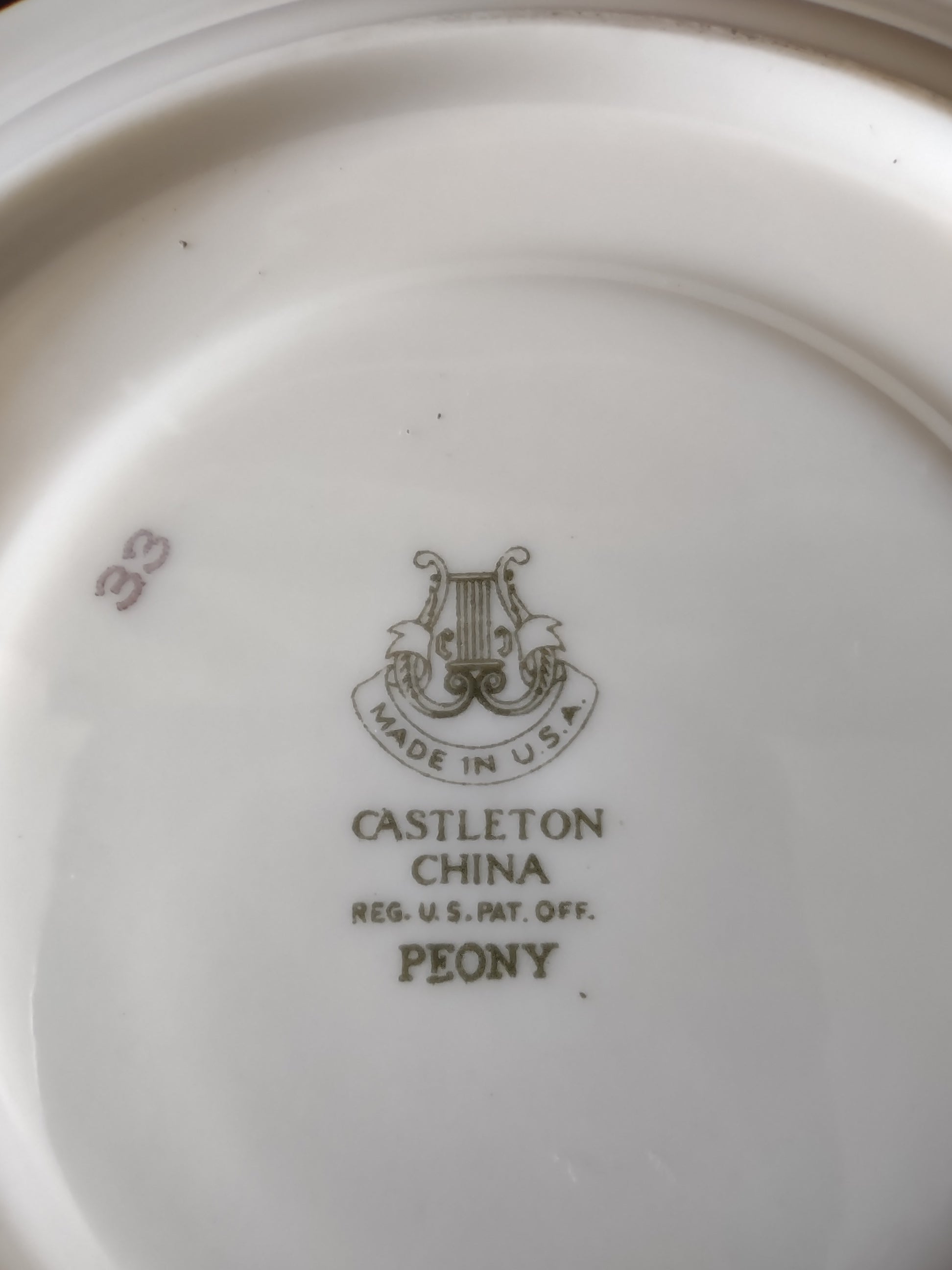 Castleton China Peony saucer front view on display stand