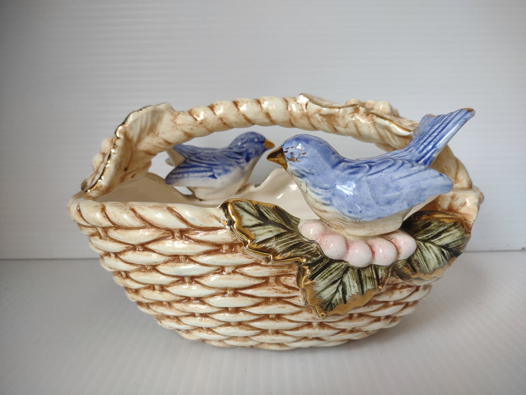 Vintage ceramic bluebird basket figurine with two blue birds, gold accents, and pink berries