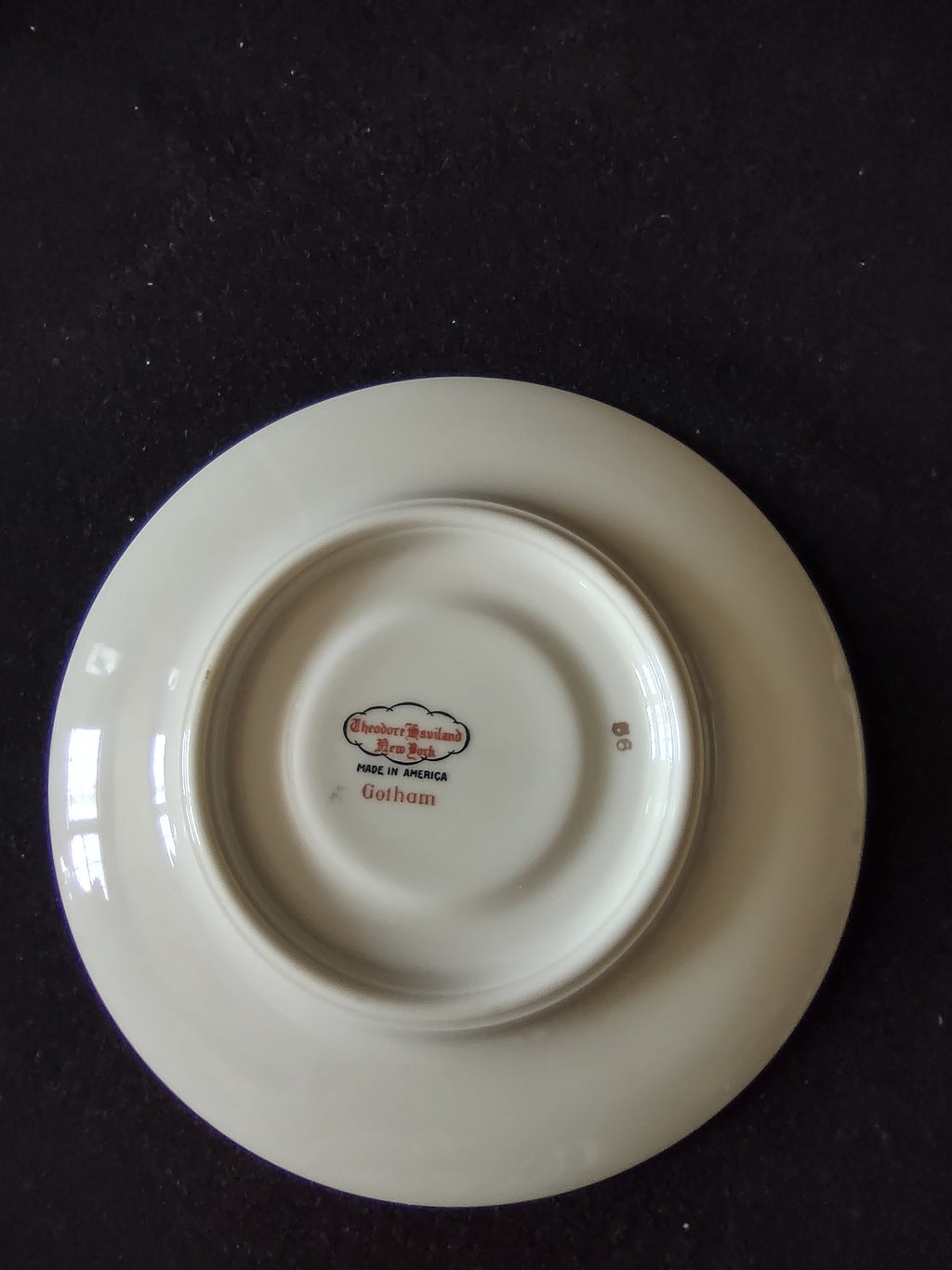 Gotham cup side view showing gold band and footed base