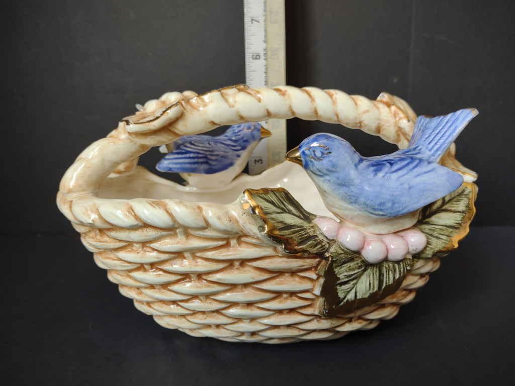 Vintage ceramic bluebird basket figurine side view with ruler showing approximately 7 inches tall