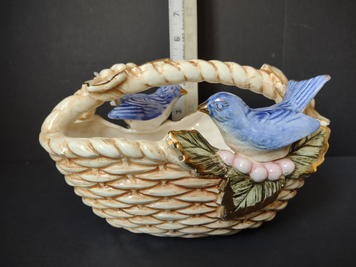Vintage ceramic bluebird basket figurine side view with ruler showing approximately 7 inches tall