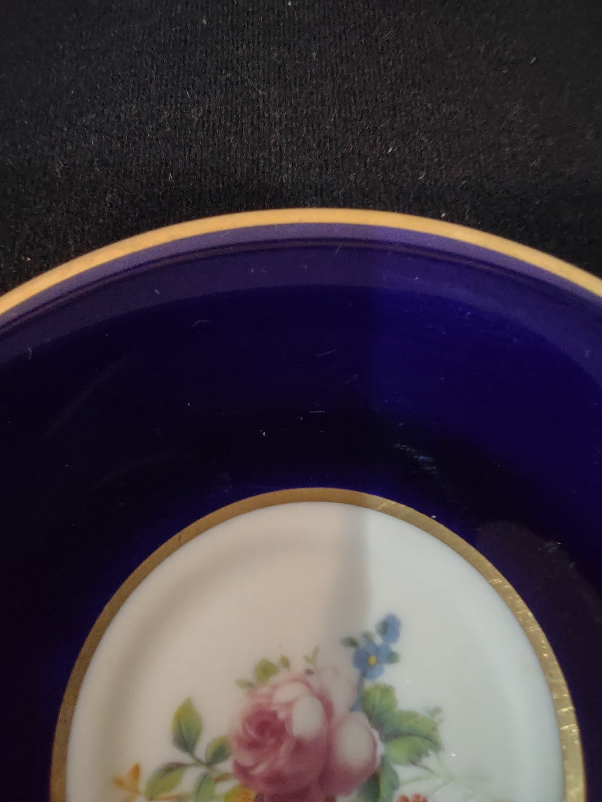 Syracuse China cobalt blue saucer top view with floral bouquet