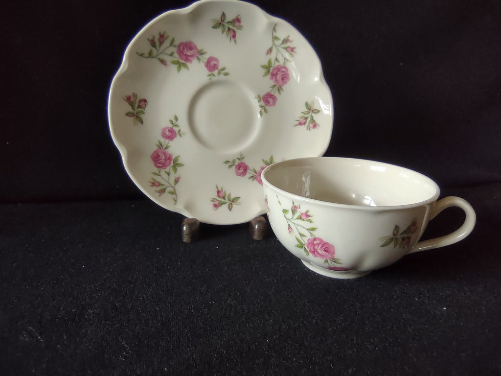 Side view of Theodore Haviland Delaware cup with pink roses and green leaves