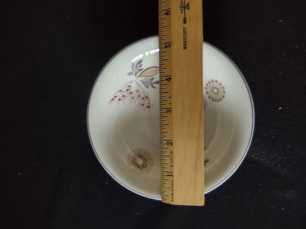 Close-up of Theodore Haviland Meadow Lace saucer center showing dark berry and seed pod spray with purple-gray and tan leaves on white porcelain