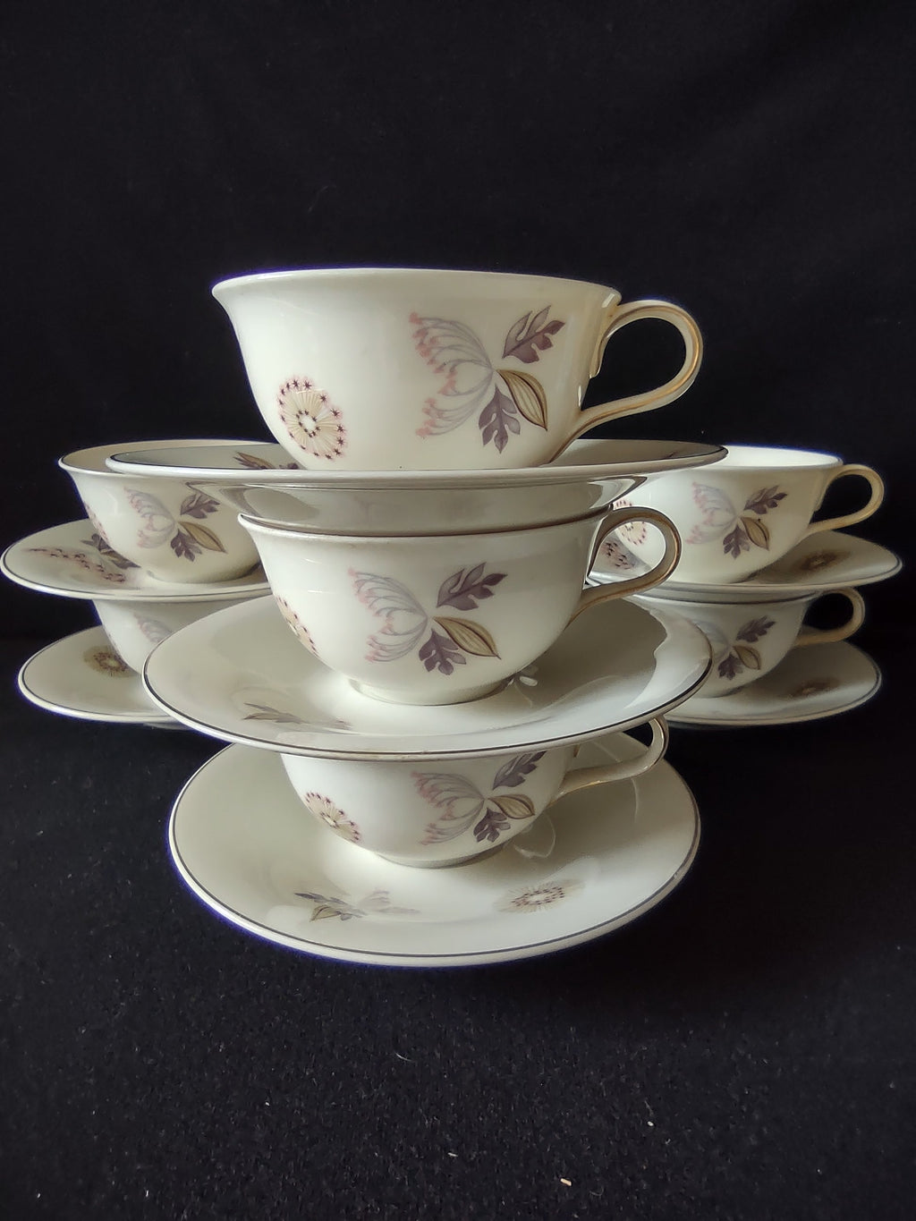 Vintage Lenox cup and saucer set of 5 stacked, showing floral pink and gray pattern with platinum rim