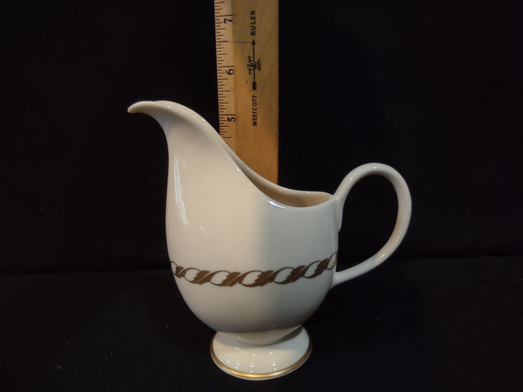 Vintage Franciscan Masterpiece China footed creamer with gold chain band and gold rim, approximately 5 inches tall, side view with ruler