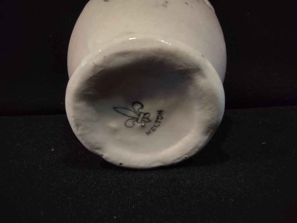 Bottom of antique lustre ware tea cup showing fleur-de-lis backstamp with heavy DISCOLORATION on unglazed base