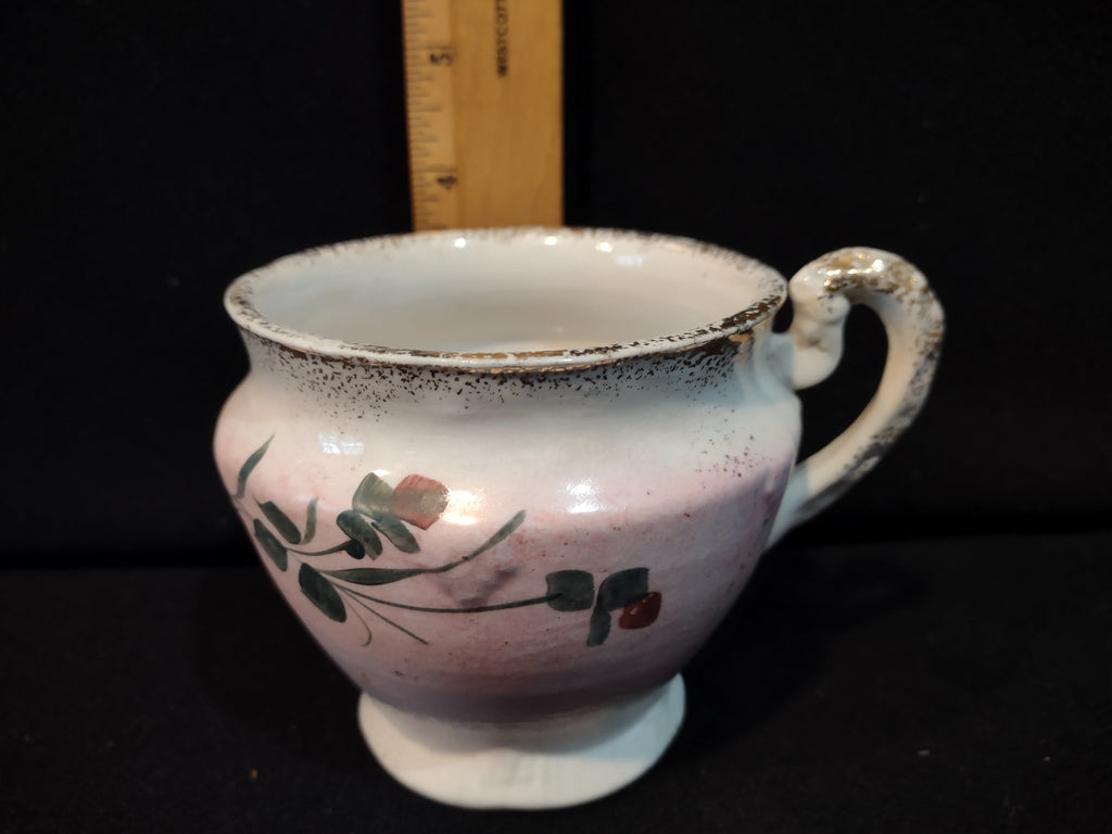 Antique pink lavender lustre ware tea cup with hand-painted green leaves and red berries, silver speckled rim, scrolled handle, approximately 3 inches tall