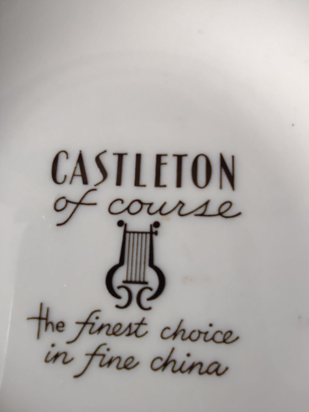 Castleton China butter pat interior view showing backstamp and plain white surface
