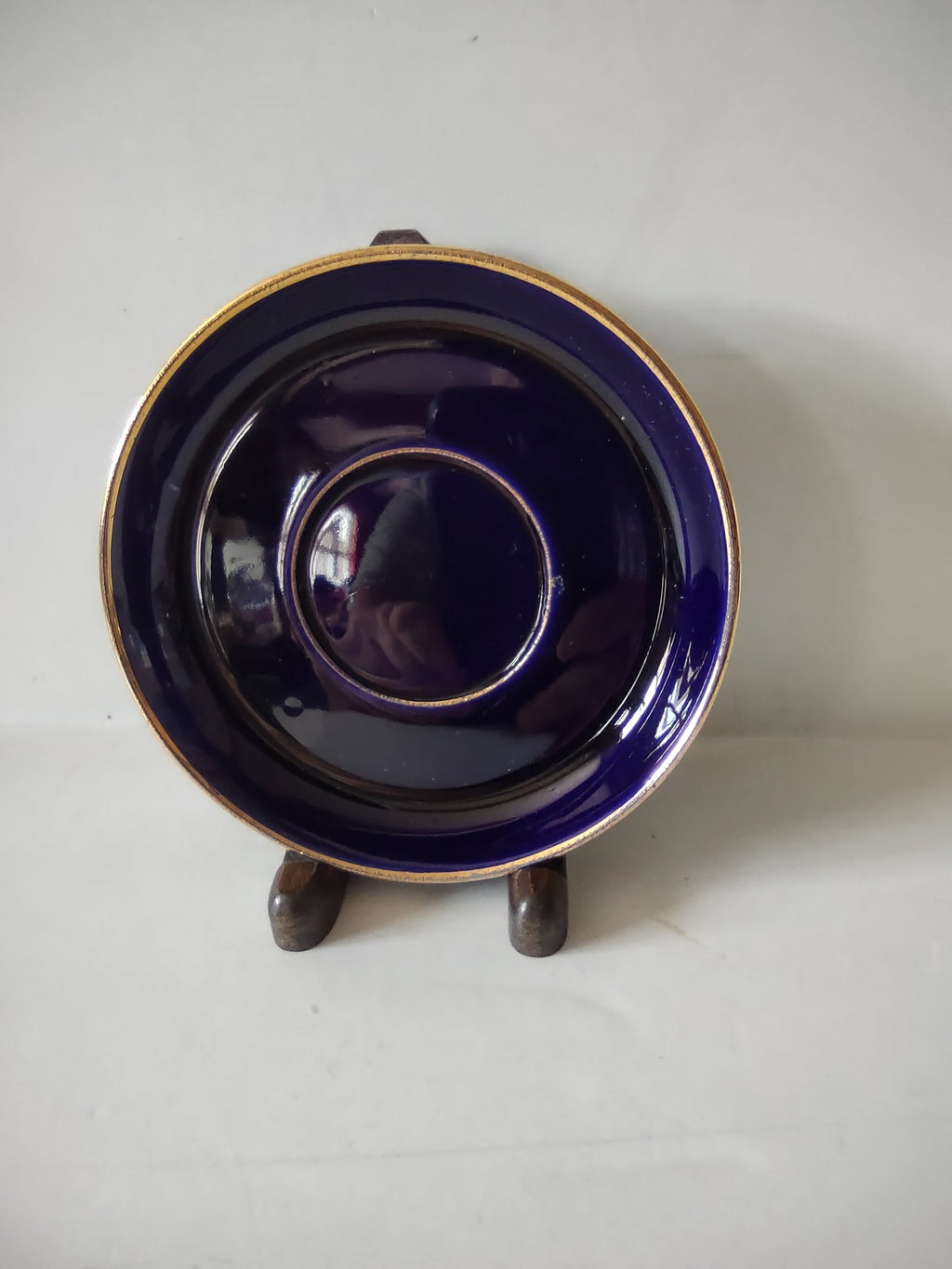 Vintage cobalt blue saucer with gold trim bands side profile view