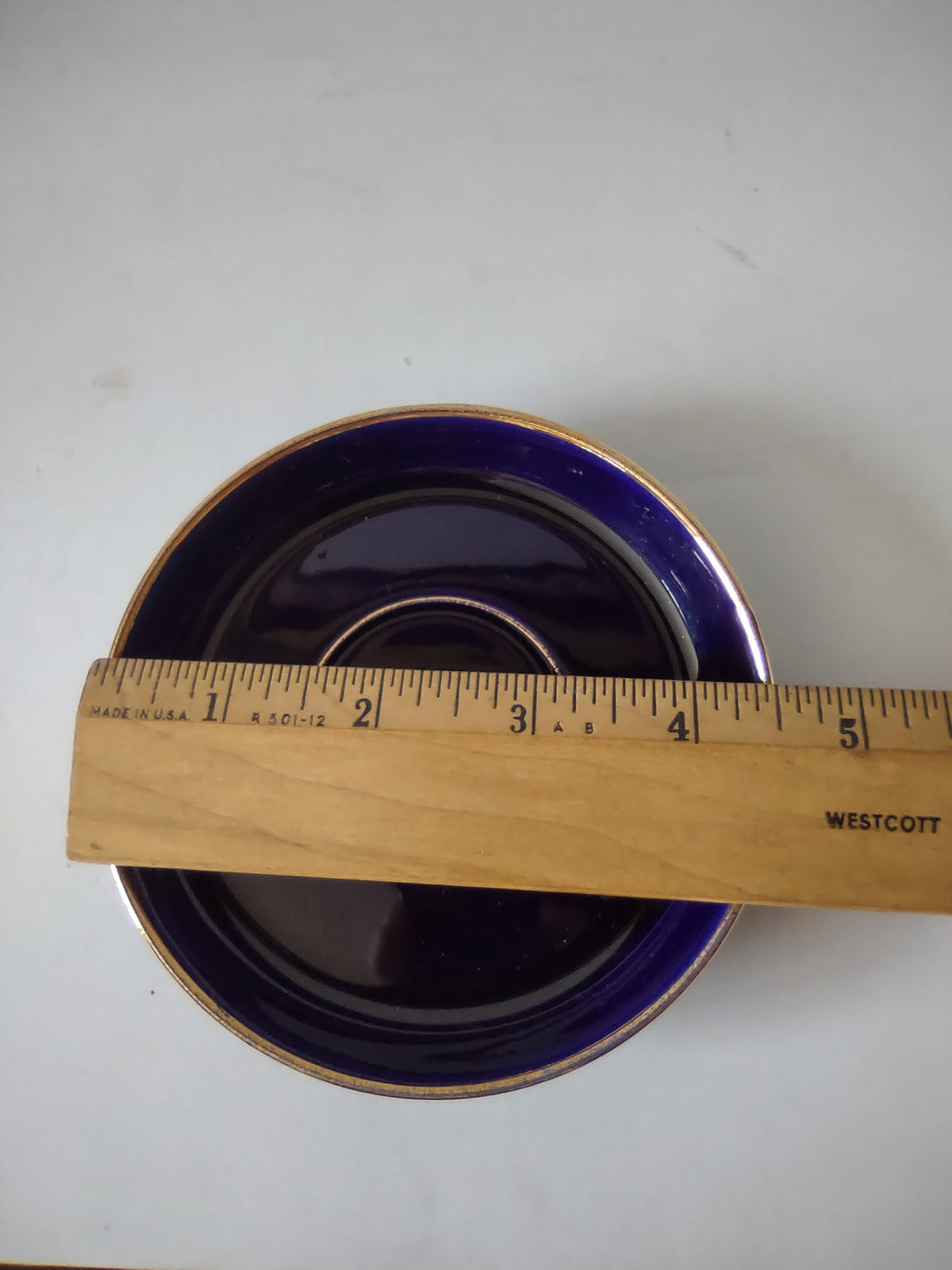 Vintage cobalt blue saucer top view showing double gold rim band and cup well ring