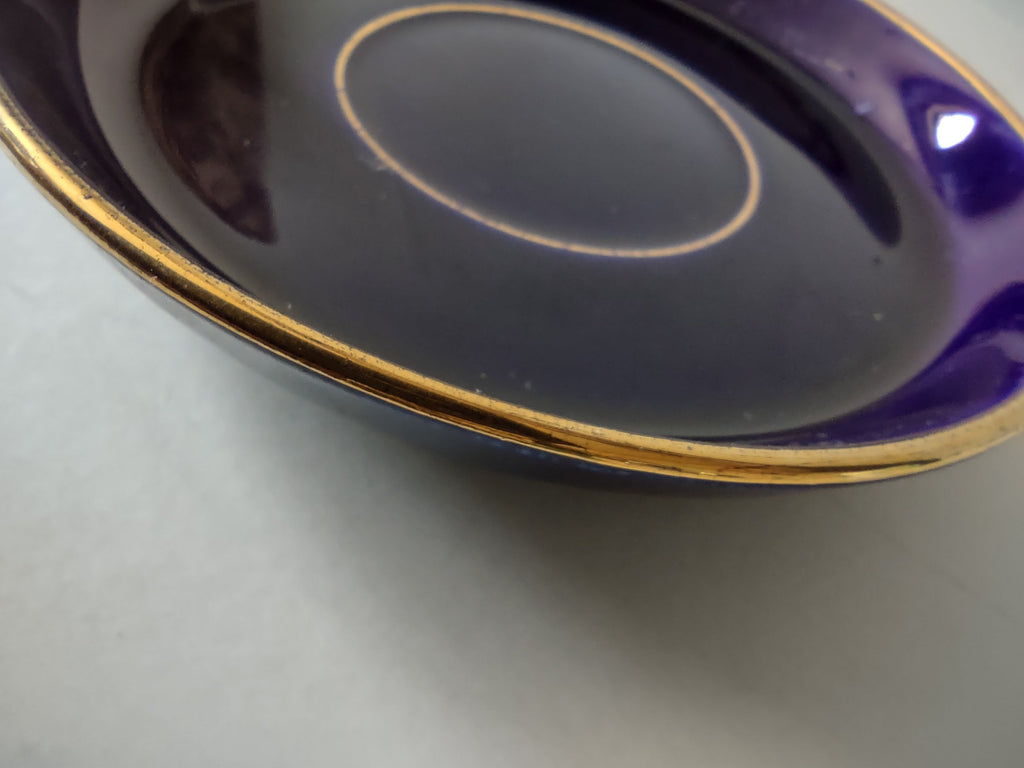 Cobalt blue saucer with ruler showing approximately 4.5 inch diameter