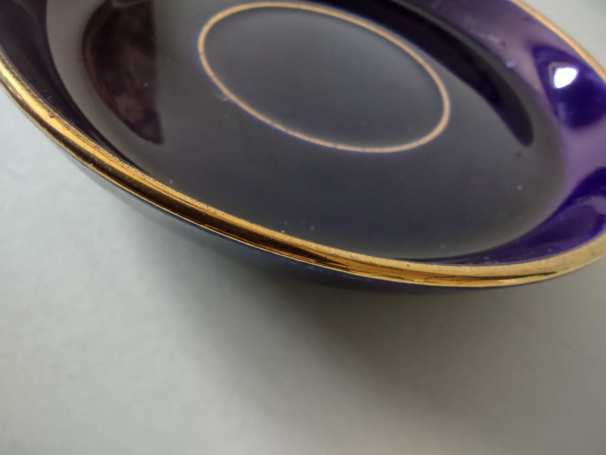 Cobalt blue saucer with ruler showing approximately 4.5 inch diameter