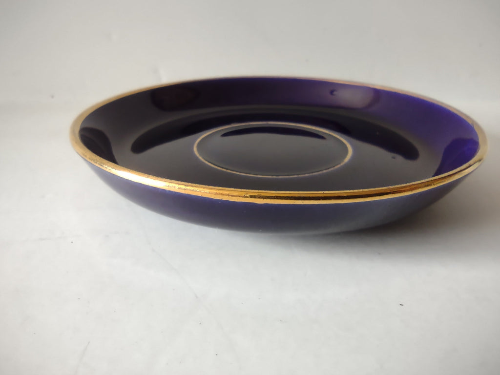 Cobalt blue saucer top view showing interior glaze and gold ring around cup well