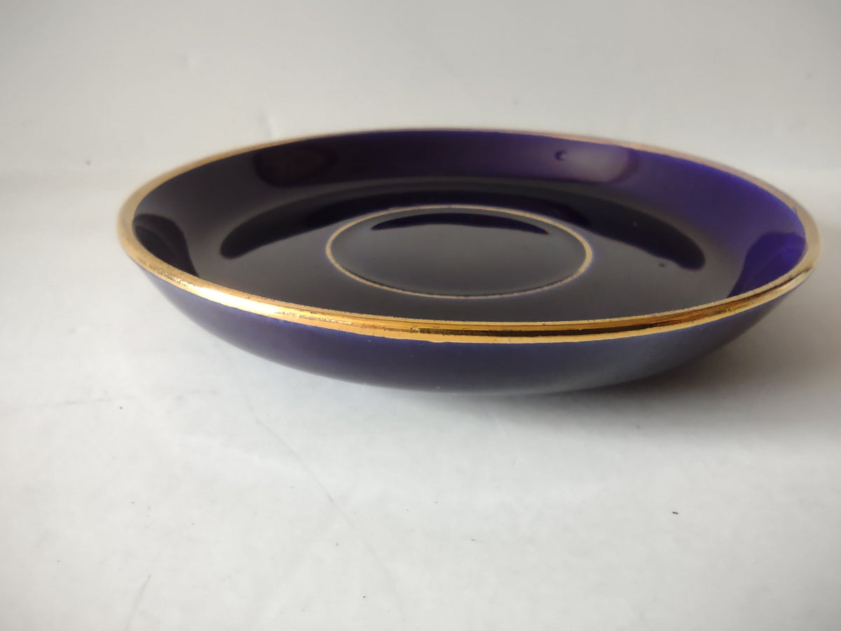 Cobalt blue saucer top view showing interior glaze and gold ring around cup well