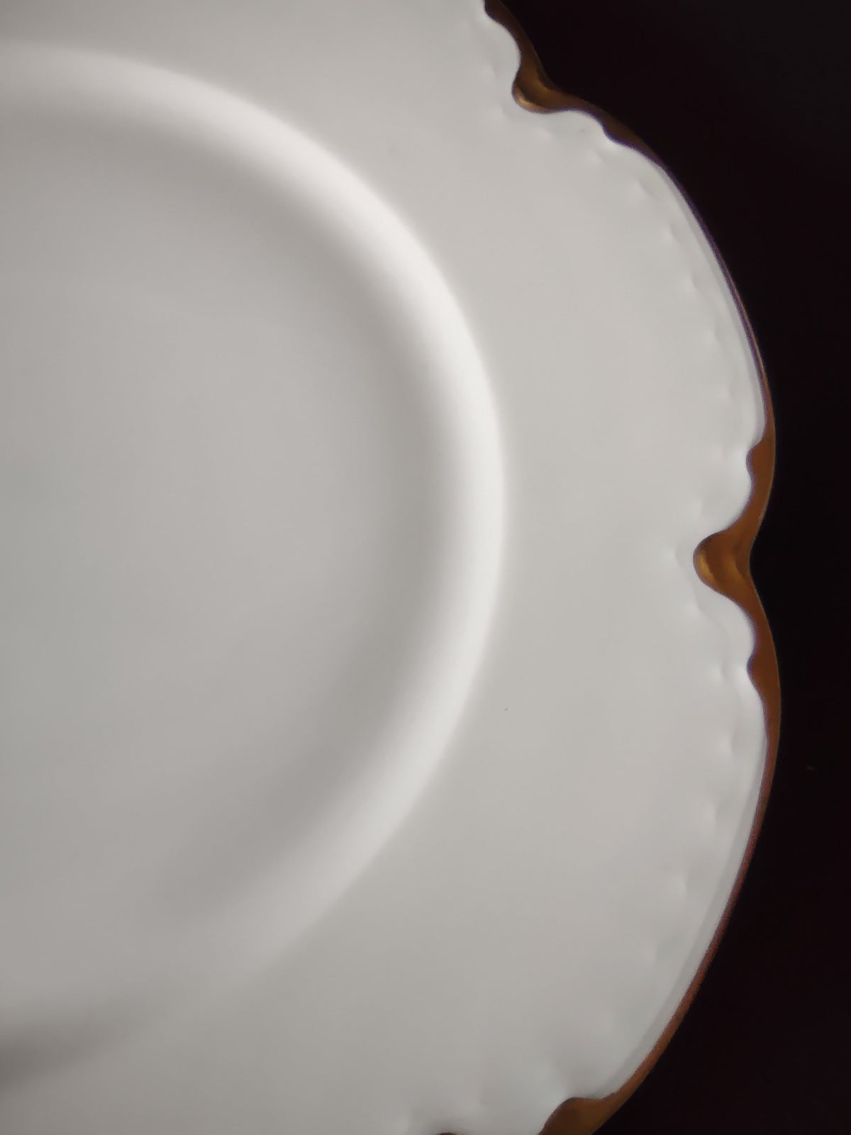 Vintage off-white scalloped gold trim porcelain plate with ruler showing approximately 9 inch diameter