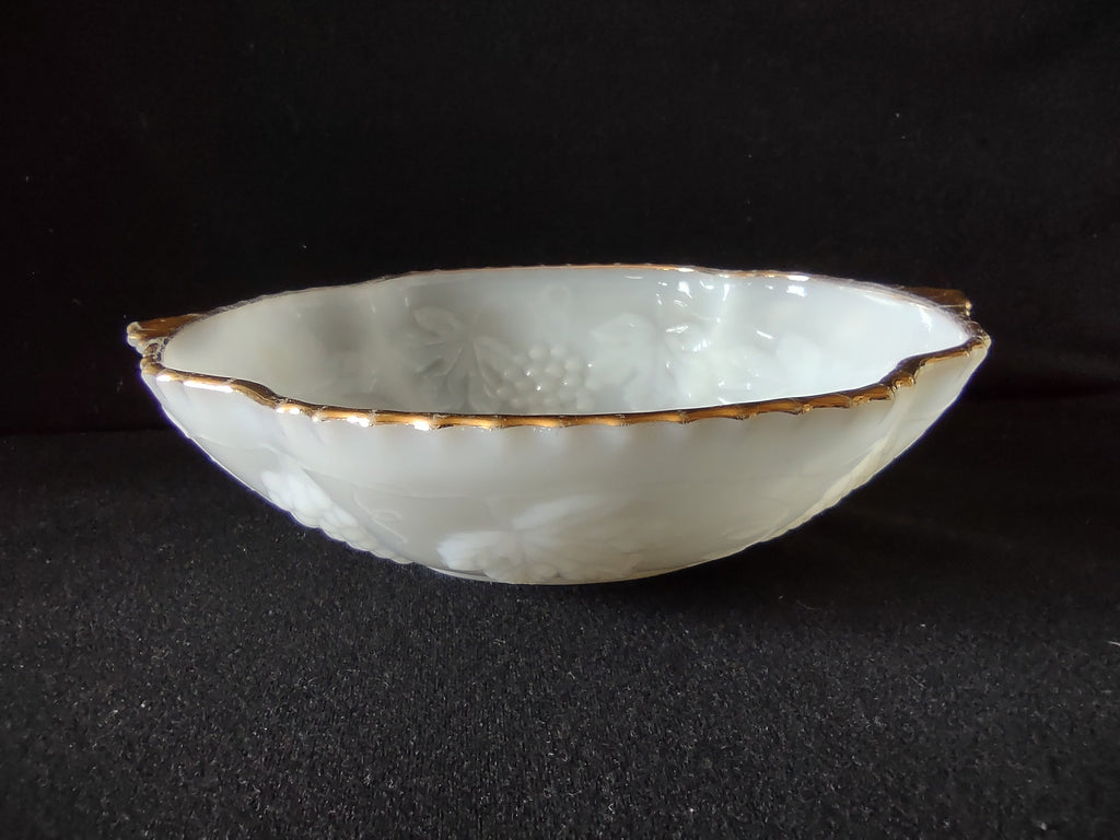 Vintage white embossed grape and leaf plate with gold rim - overhead view