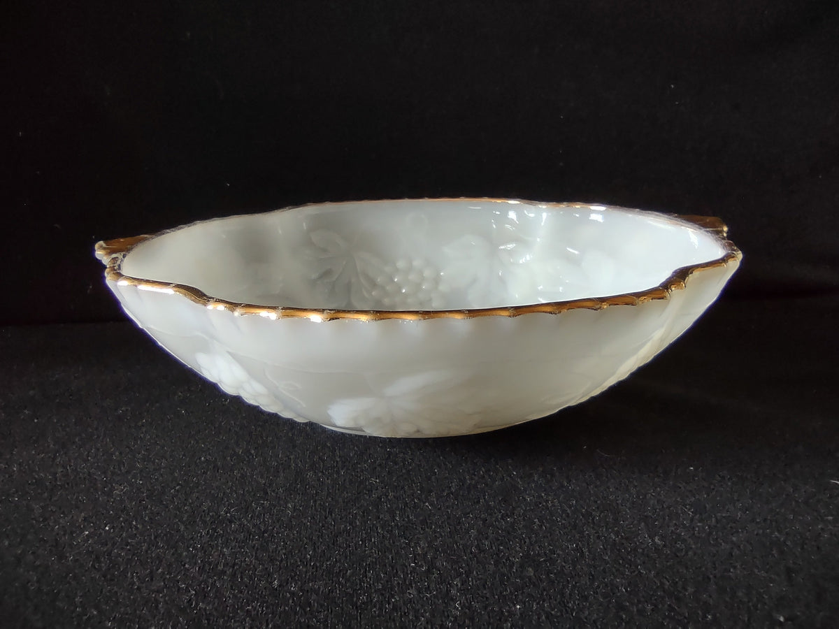 Vintage white embossed grape and leaf plate with gold rim - overhead view