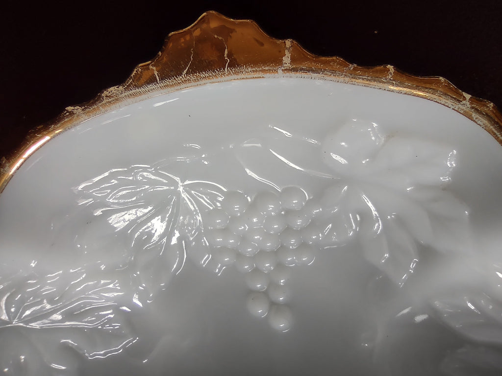 Gold scalloped rim detail on white embossed plate