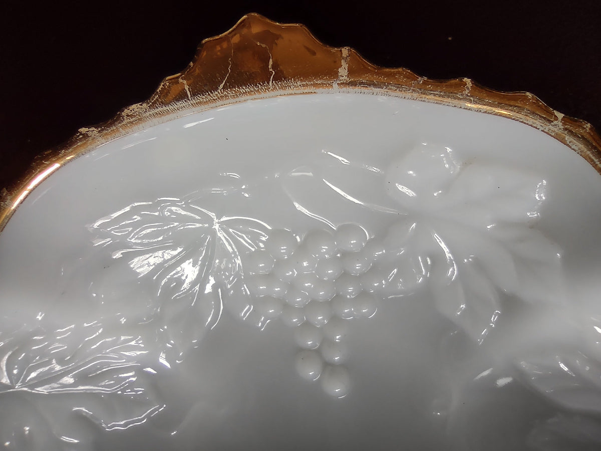Gold scalloped rim detail on white embossed plate