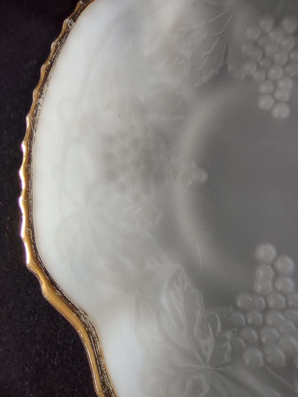 Interior well of white embossed grape plate
