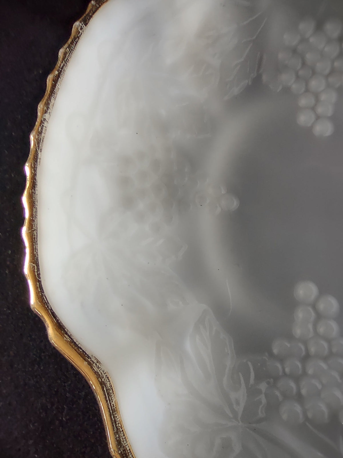 Interior well of white embossed grape plate