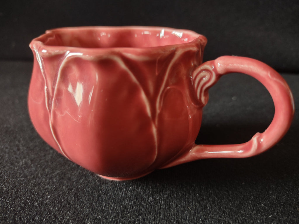 Vintage pink tulip creamer close-up side view showing looped handle and petal relief