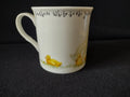 Interior rim with feathers white text and yellow duckling motifs