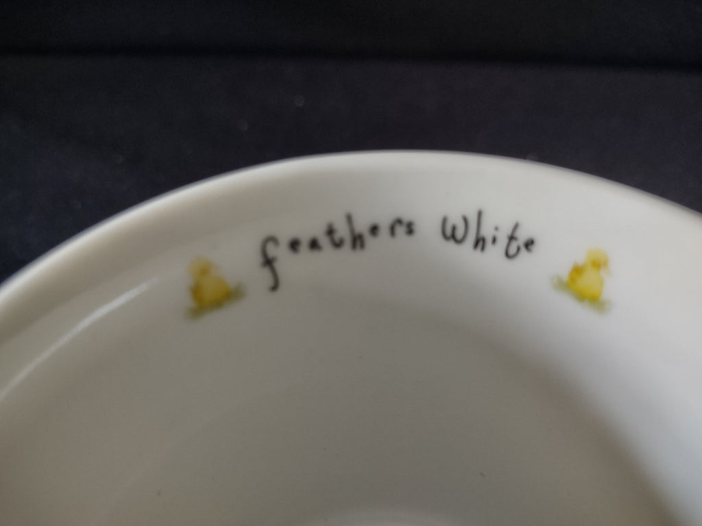 Top view showing interior with feathers white text and yellow ducklings
