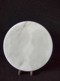 White marble round trivet serving board - front view on display stand