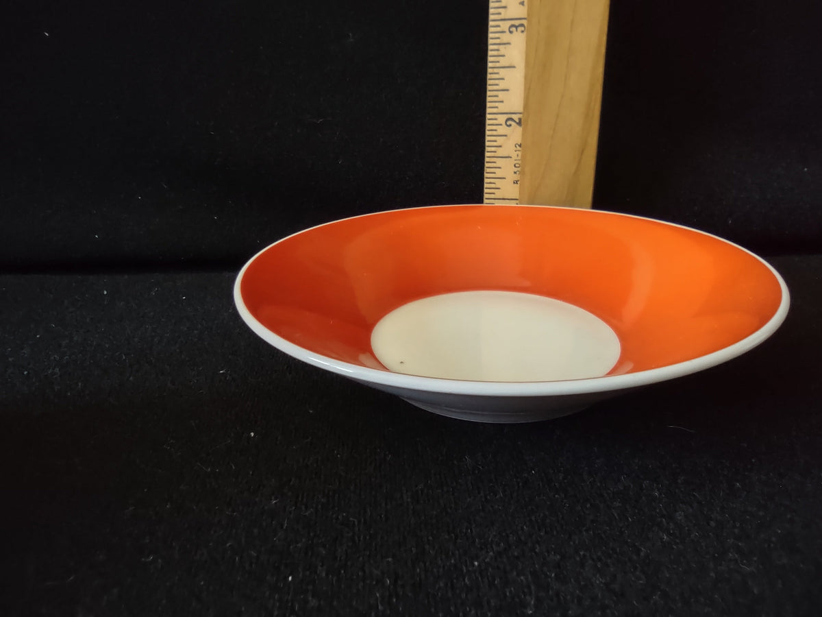 Royal Bayreuth orange saucer top view with ruler showing approximately 4.5 inch diameter