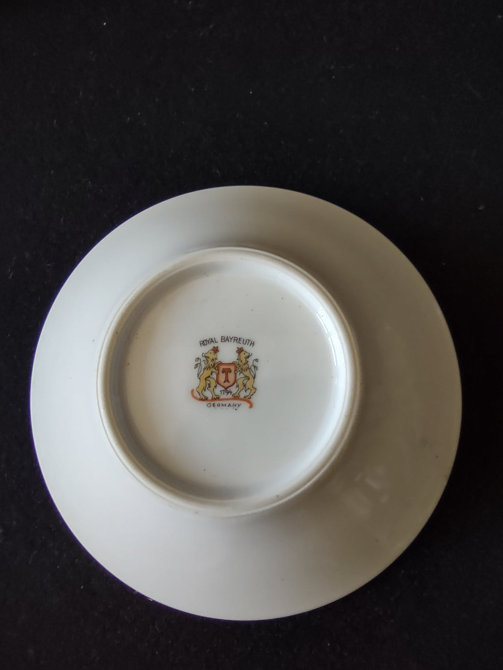 Royal Bayreuth orange cup and saucer top view showing orange interior and white center well