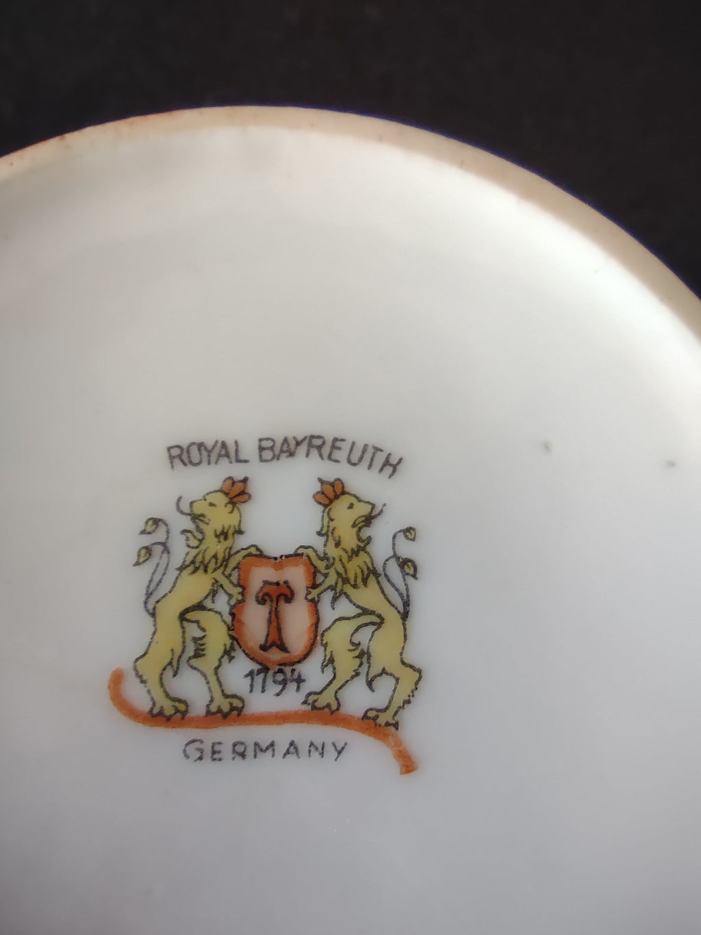 Royal Bayreuth orange cup and saucer set angled view showing bold orange glaze